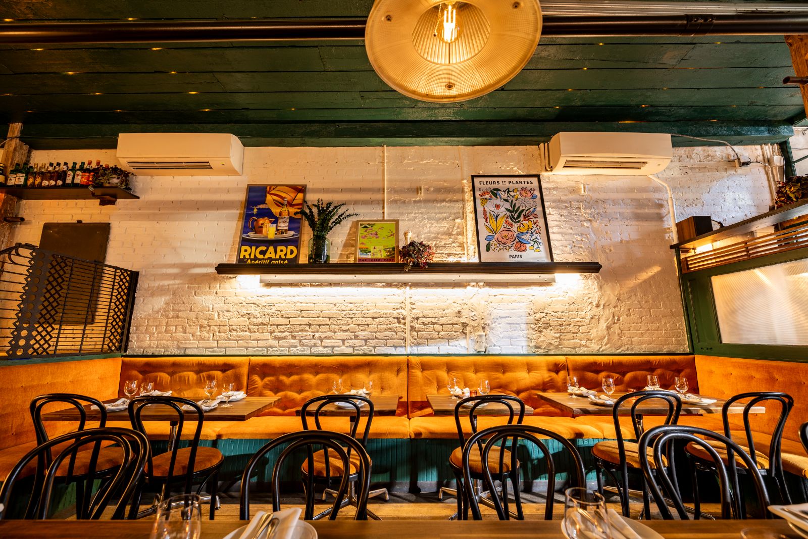 Whitewashed brick and bistro chairs